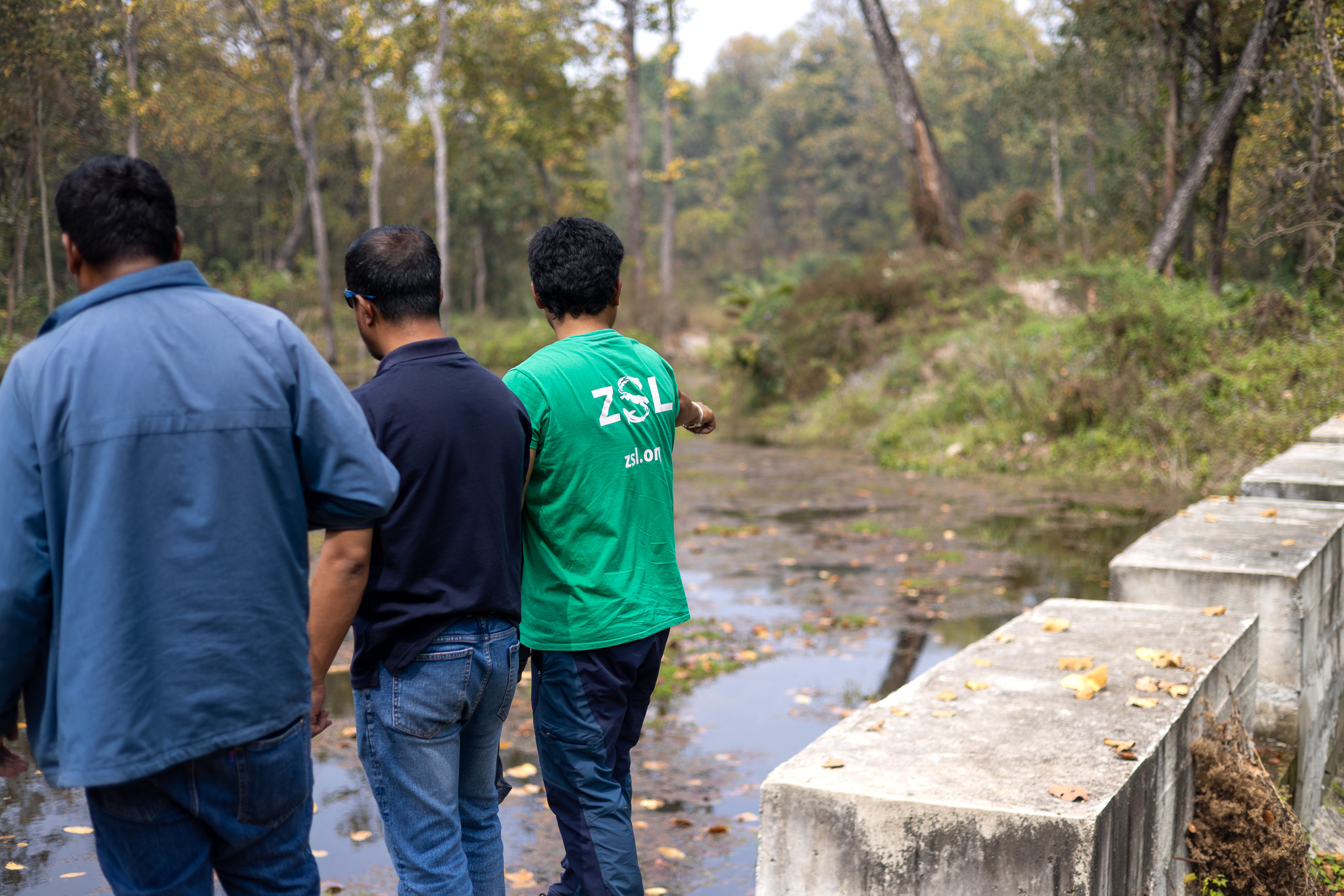 ZSL Nepal team by a human built lake